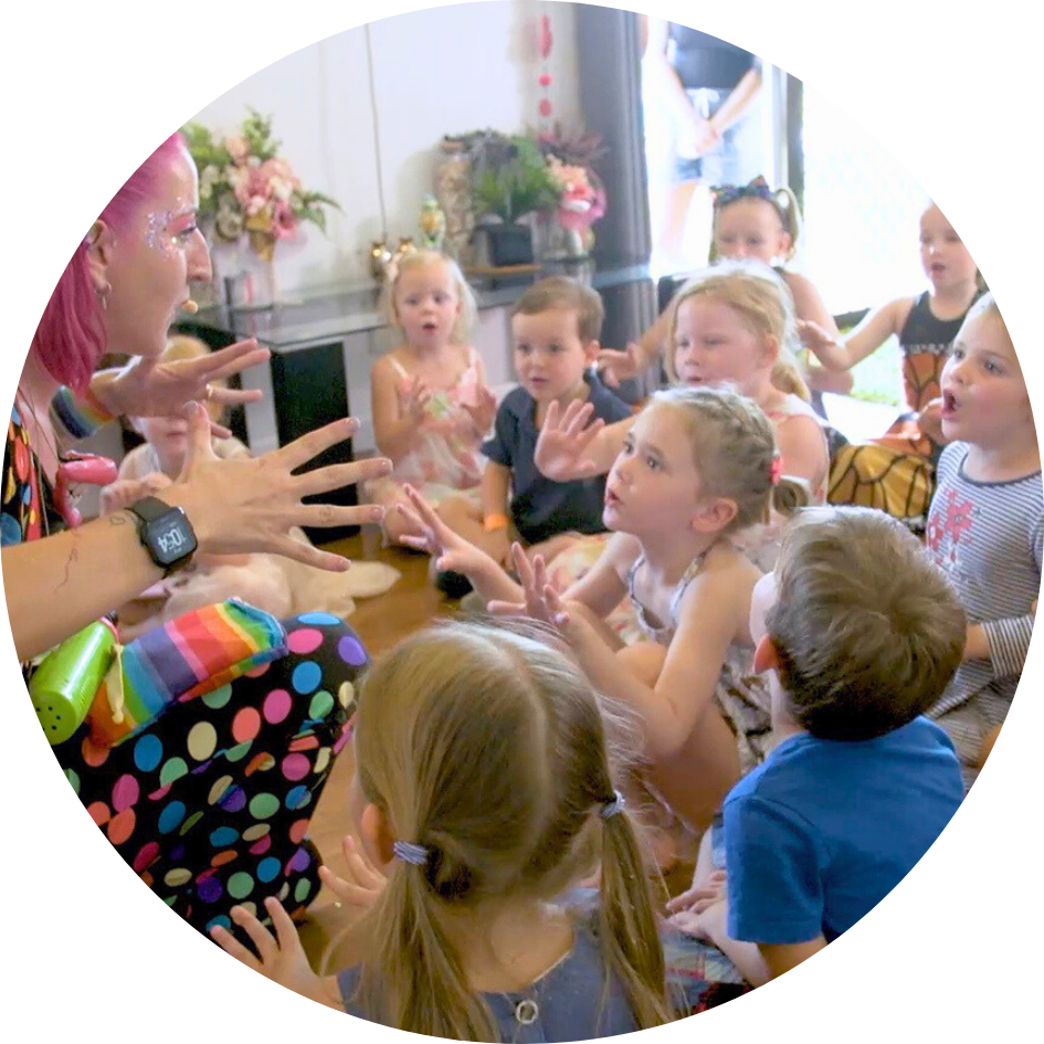 A group of children watch intently during an interactive magic show at a Darwin birthday party.