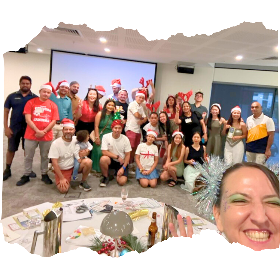 A group photo with corporate clients and Hyper the Clown at a murder mystery event in Darwin.